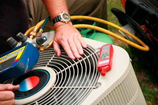 HVAC maintenance with diagnostic tools and hoses on an outdoor condenser
